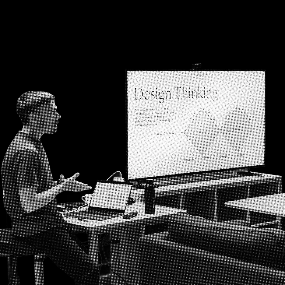 Person presenting a design thinking process on a screen during a workshop