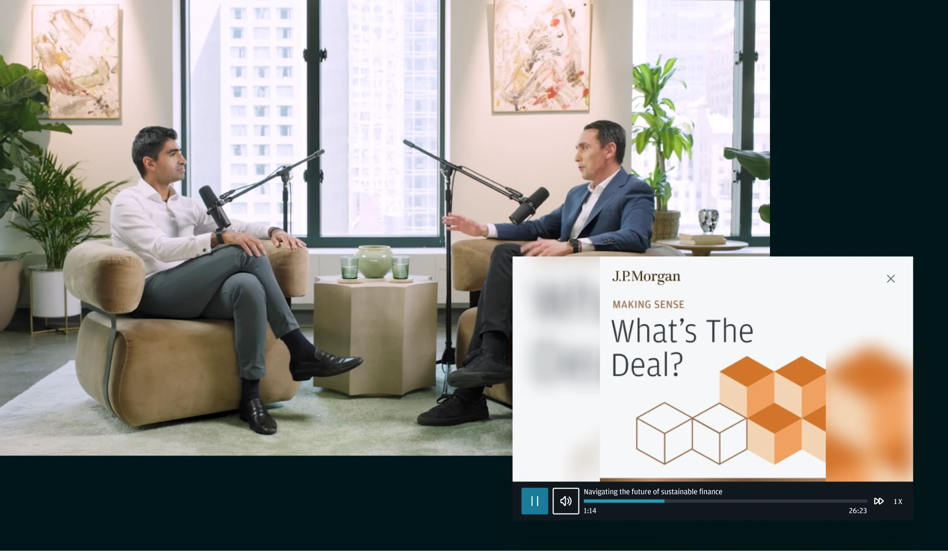 Two business professionals seated in a modern office recording a finance podcast with microphones, with a J.P. Morgan “What’s The Deal?” video player overlay visible.