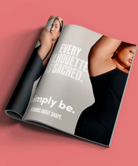 Simply Be body positivity print advert featuring a model in black shapewear with the message “Every silhouette is sacred