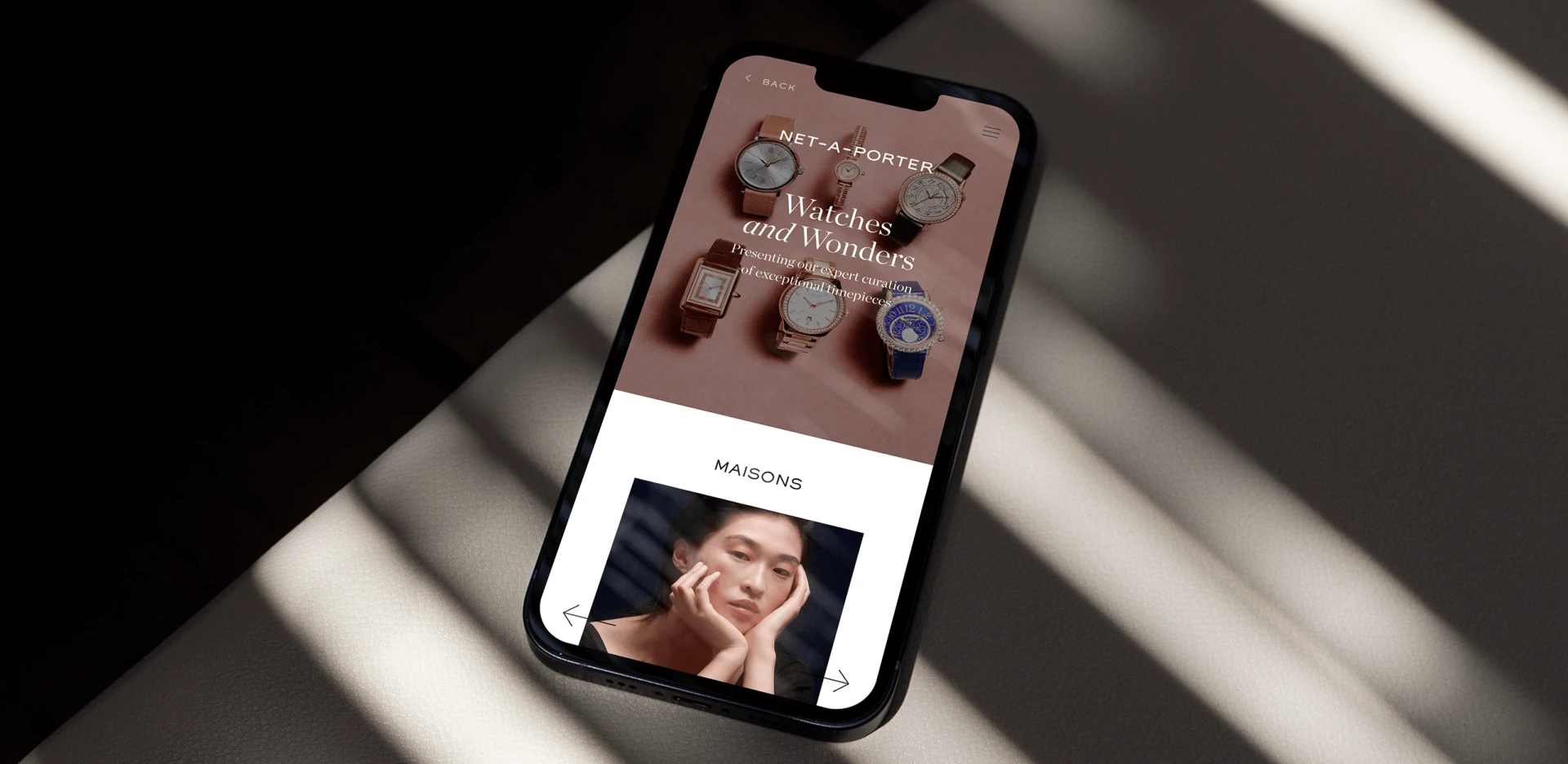 Smartphone displaying luxury watch ecommerce website design with featured timepieces